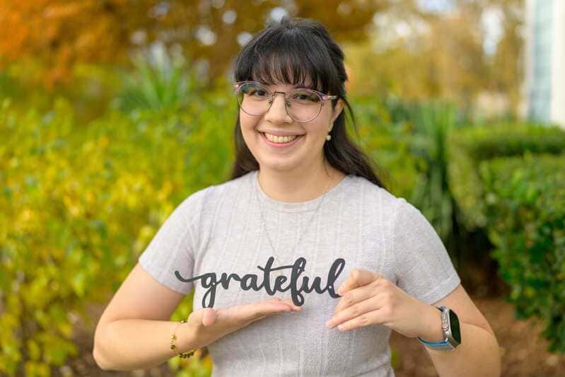 person holding sign that reads greatful